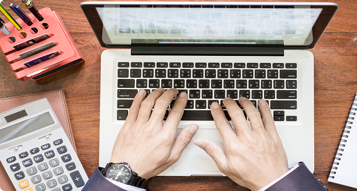 Finance manager monitoring cash flow and bank reconciliation on a laptop