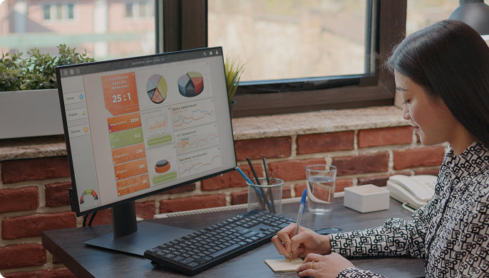 Analyst reviewing reporting dashboards on a screen